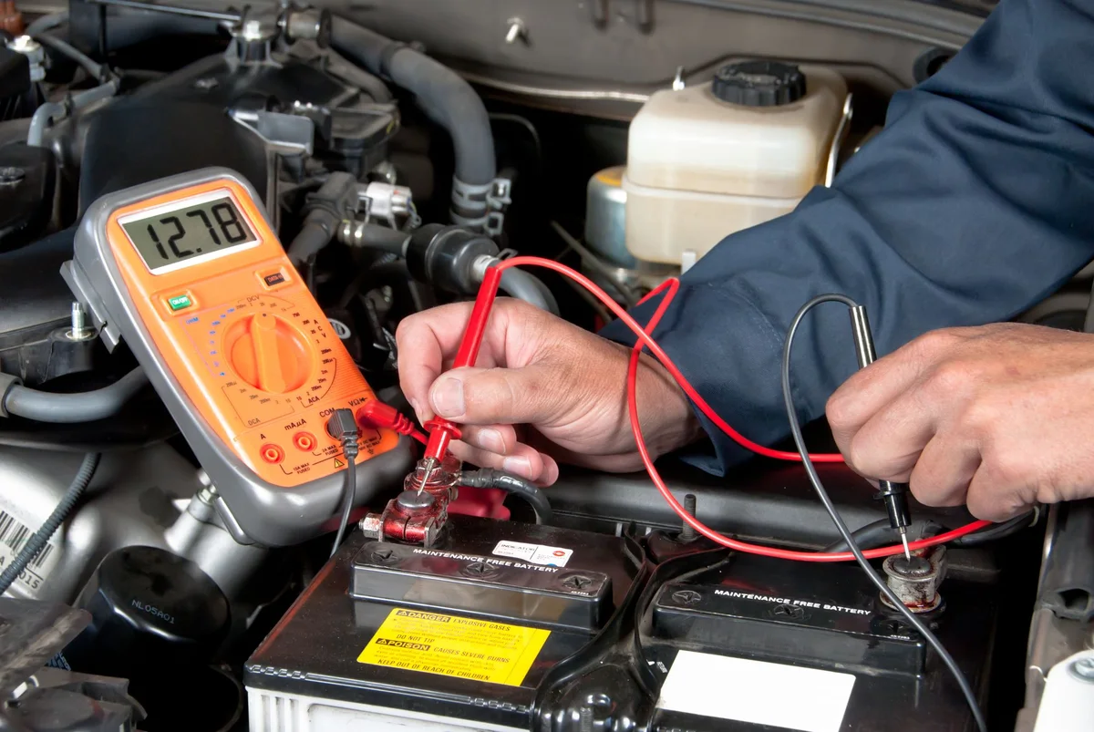 Battery tester connected to a car battery